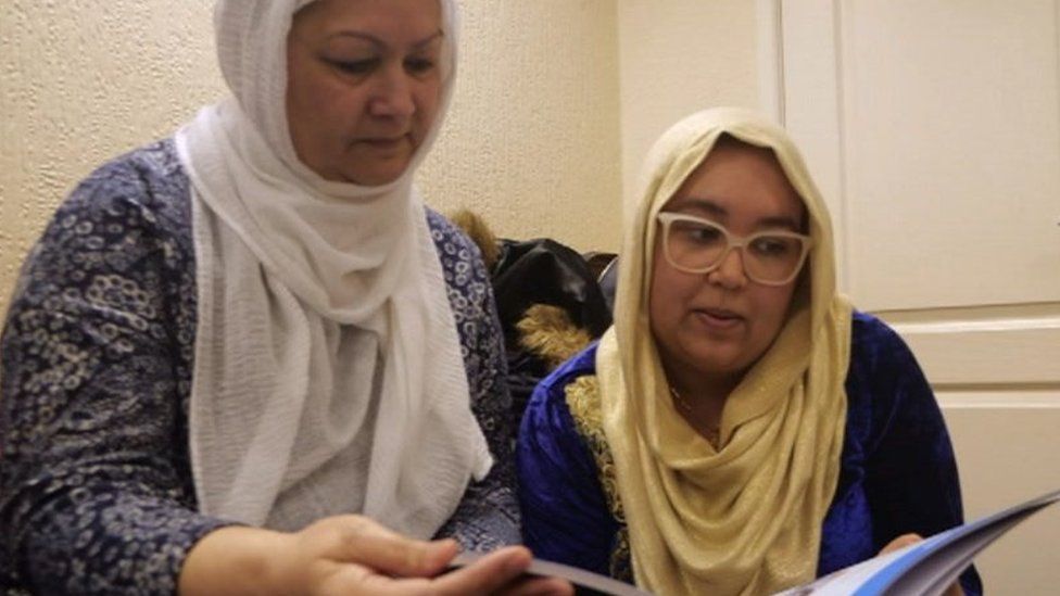 Ayesha Abdol-Hamid and her mum Shahida reading literature in the MEND office