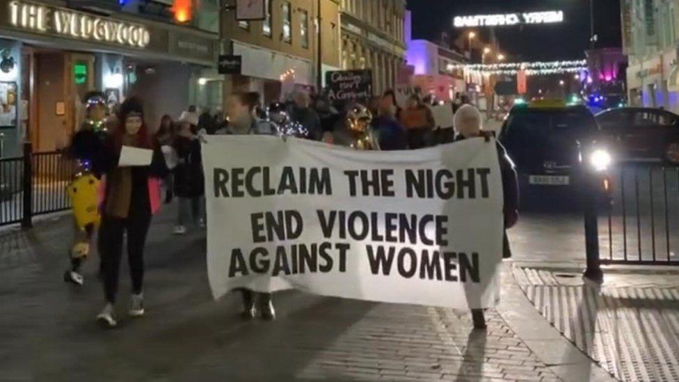 Large banner saying "reclaim the night, end violence against women"
