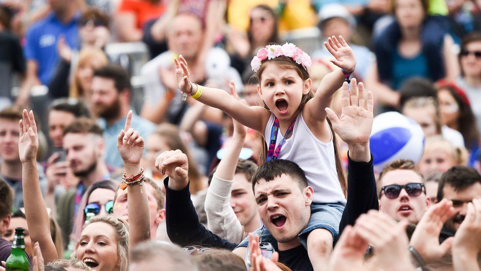 A young girl leads the cheers as Ed Sheeran performs during the first day of BBC Music's Biggest Weekend in Swansea