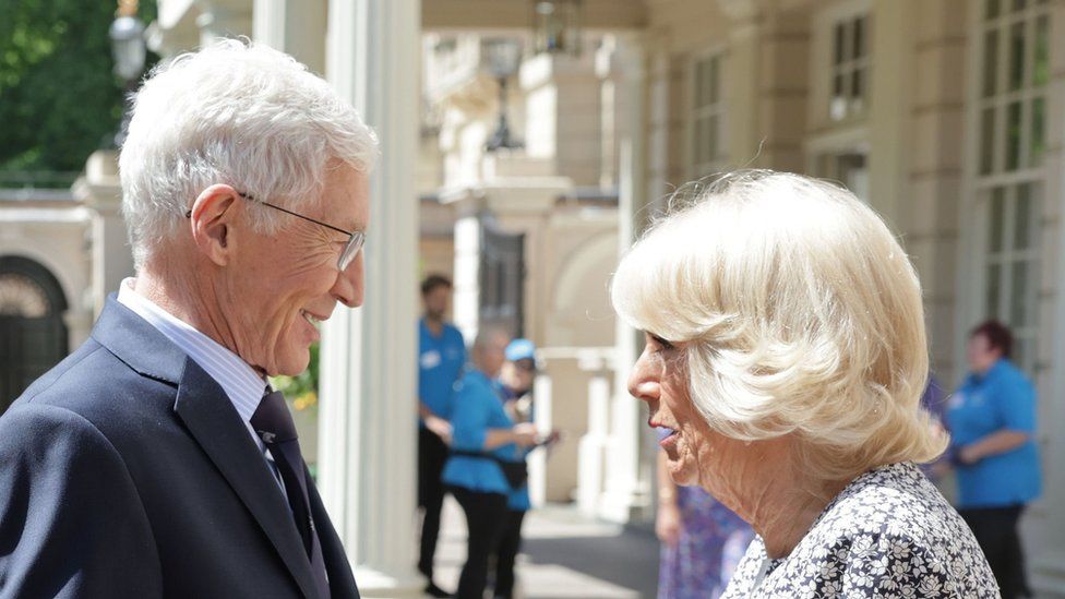 Paul O'Grady smiles at the Queen Consort