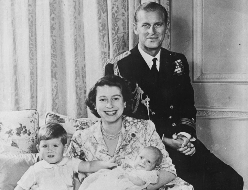 A portrait of Princess Elizabeth and Prince Philip smiling with their baby daughter Princess Anne and son Prince Charles at Buckingham Palace, London, on 21 October, 1950