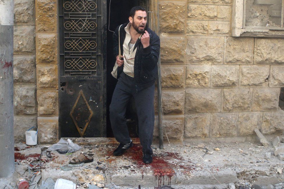 A man gestures after a reported barrel bomb attack in the rebel-held Firdous district of Aleppo (29 April 2016)