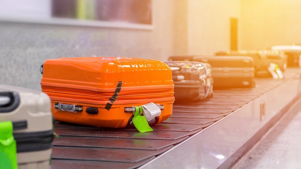 Suitcase or luggage with conveyor belt in the airport - Stock image