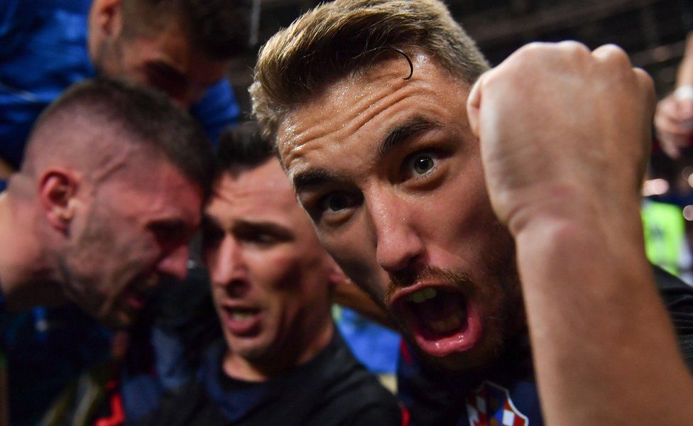 Croatia"s defender Josip Pivaric (R) celebrates with teammates