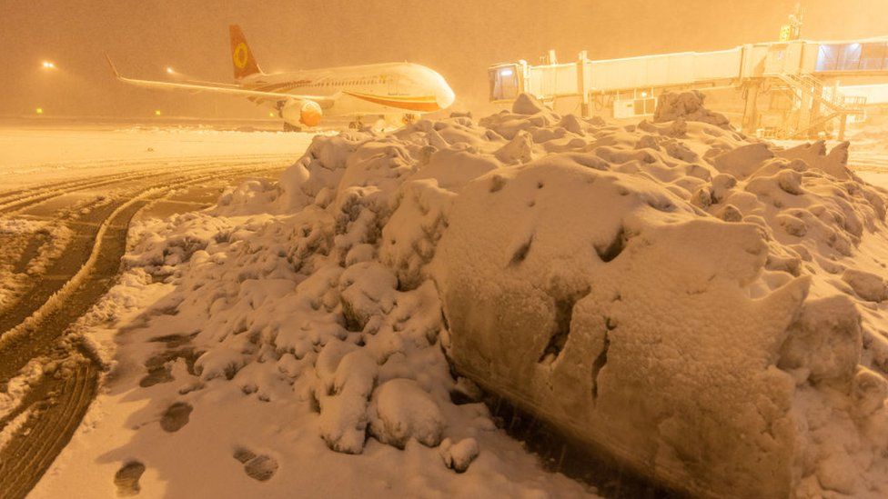 A Chengdu Airlines Airbus A320 aircraft stands at Shenyang Taoxian International Airport during a heavy snowfall on November 8, 2021 in Shenyang, Liaoning Province of China