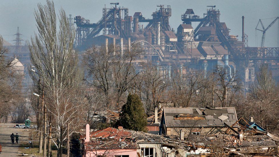 A view shows a plant of Azovstal Iron and Steel Works company behind buildings damaged in the besieged southern port city of Mariupol, Ukraine, on 28 March 2022