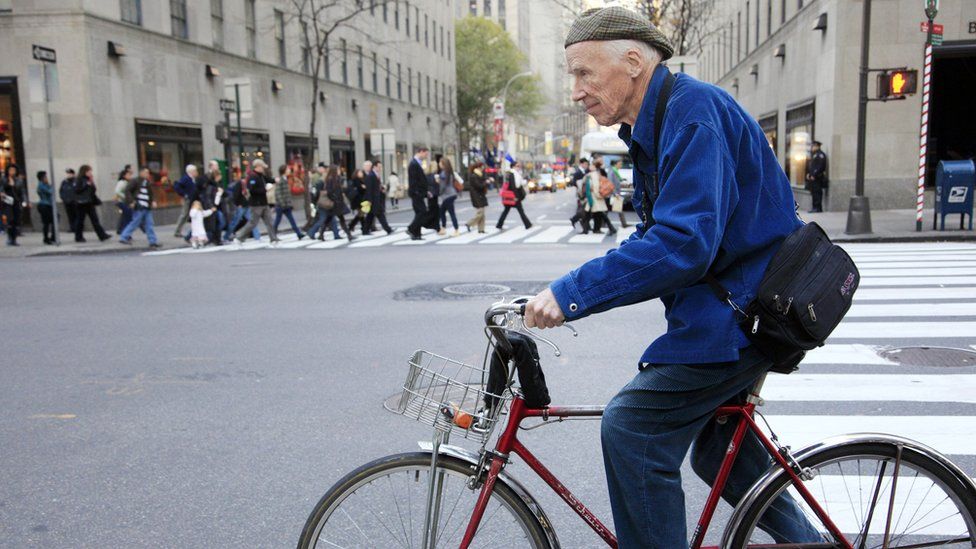 Bill Cunningham riding a bicycle on the streets of New York