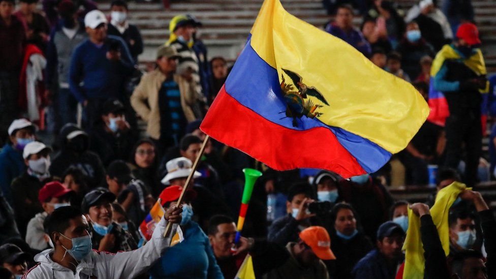 A demonstrator waves an Ecuadorian flag during a cultural festival amid a stalemate