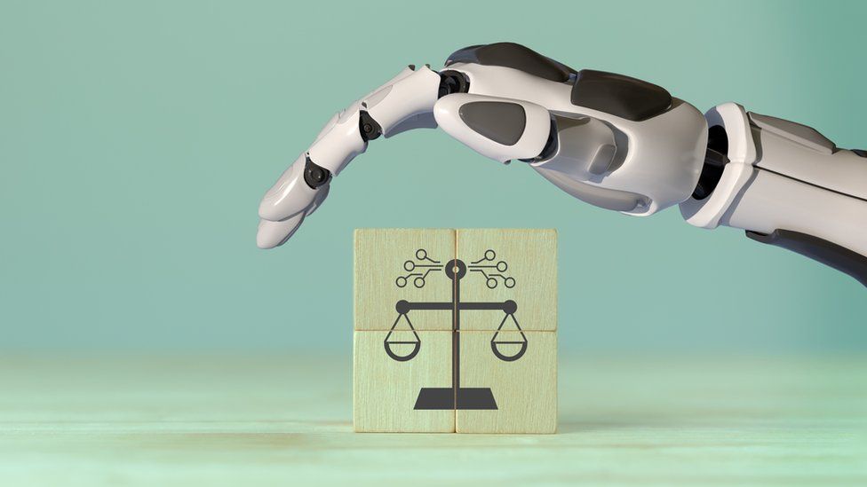 The hand of an AI robot hovers over a justice sign