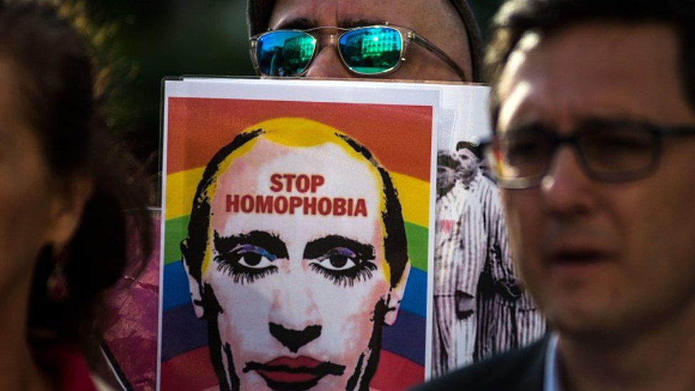 A man showing a picture of Vladimir Putting during a protest supporting LGTB in Chechnya