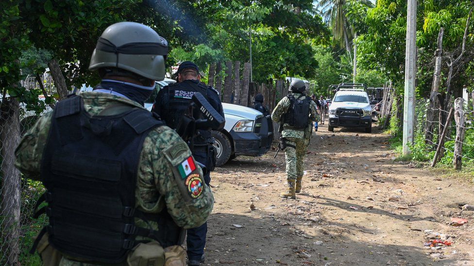 Mexican police and security forces inspect the area where police officers were killed in Coyuca de Benítez, Guerrero state. Photo: 23 October 2023