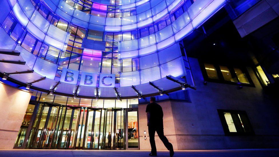 Stock image of a person walking into the BBC offices in London