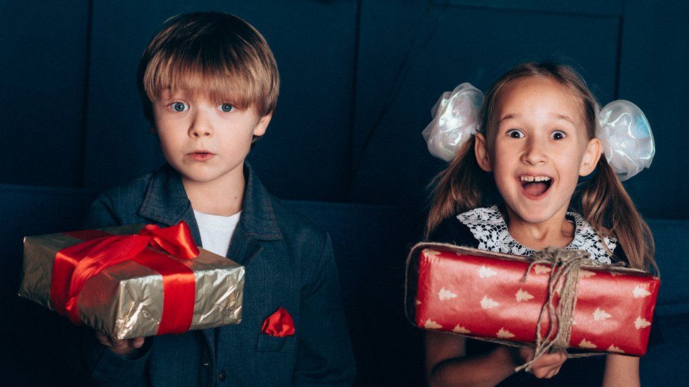 A boy and girl with presents