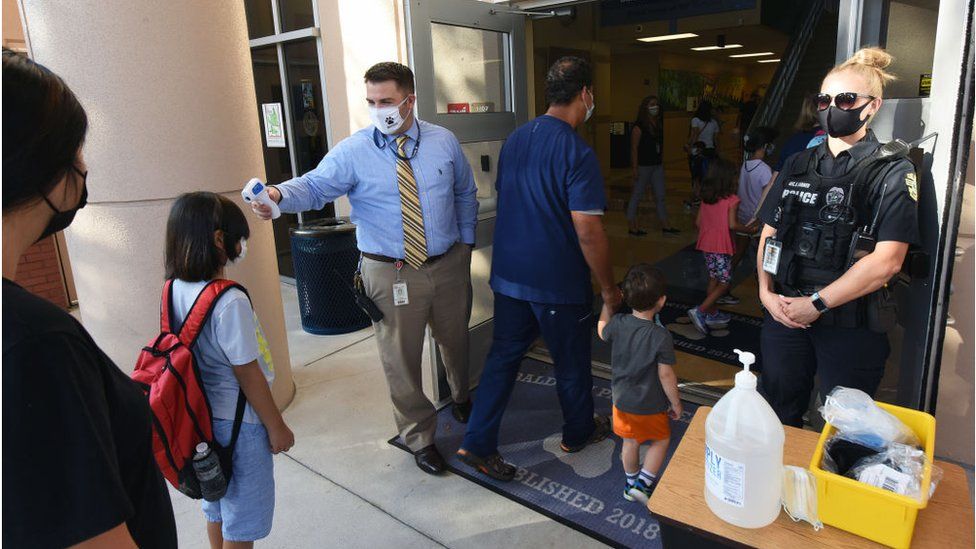 Students in a different Florida region, Orlando, have their temperatures checked