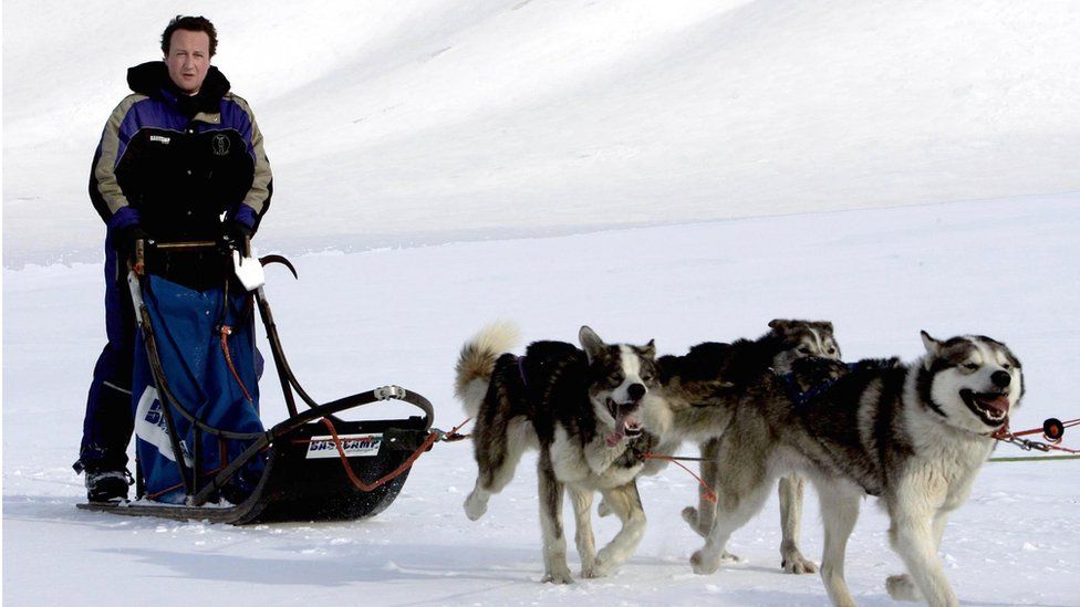 David Cameron driving a dog-sled on his way to the Scott-Turner glacier on the island of Svalbard, Norway in 2006