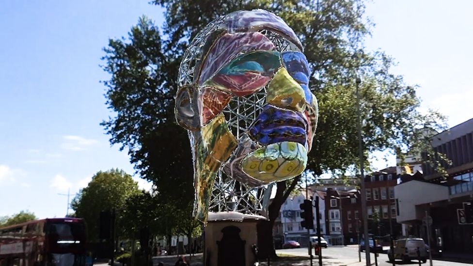 A digital statue of a large colourful head