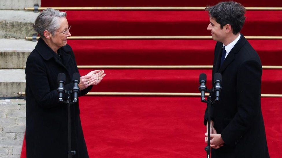 France's outgoing Prime Minister Elisabeth Borne applauds newly appointed Prime Minister Gabriel Attal during the handover ceremony at the Hotel Matignon in Paris, France, on January 9, 2024