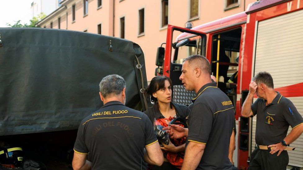 Firefighters work at the scene following a fire in a retirement home in Milan, Italy, July 7, 2023