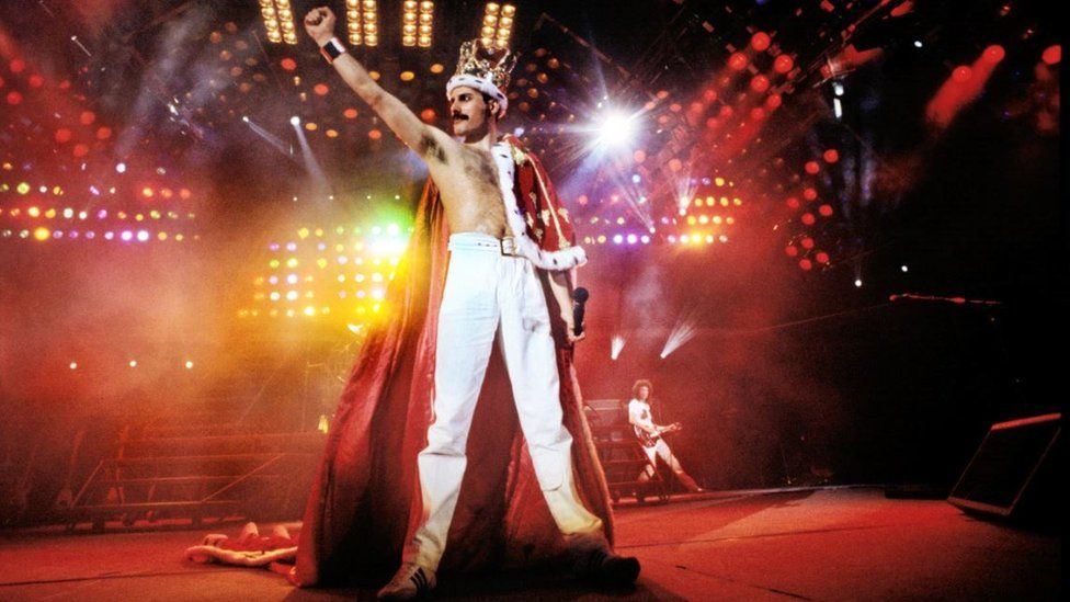 Freddie Mercury on stage wearing Crown and Cape at Wembley Stadium, 1986