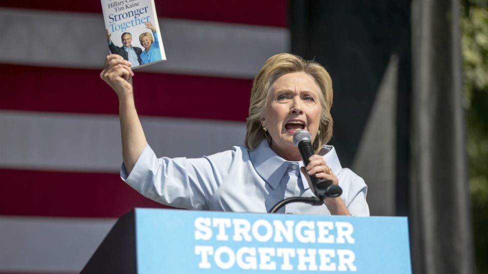 Hillary Clinton holds up a book entitled "Stronger Together" as she speaks in Cleveland, Ohio - 5 September 2016