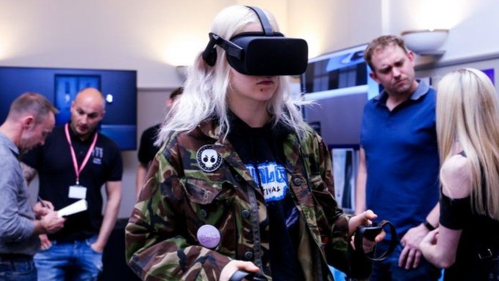 A conference attendee tries out an Oculus VR headset.