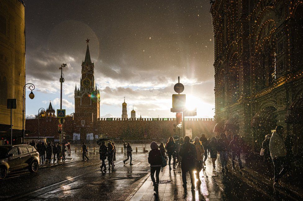People cross the Red Square in Moscow, Russia on October 23, 2021
