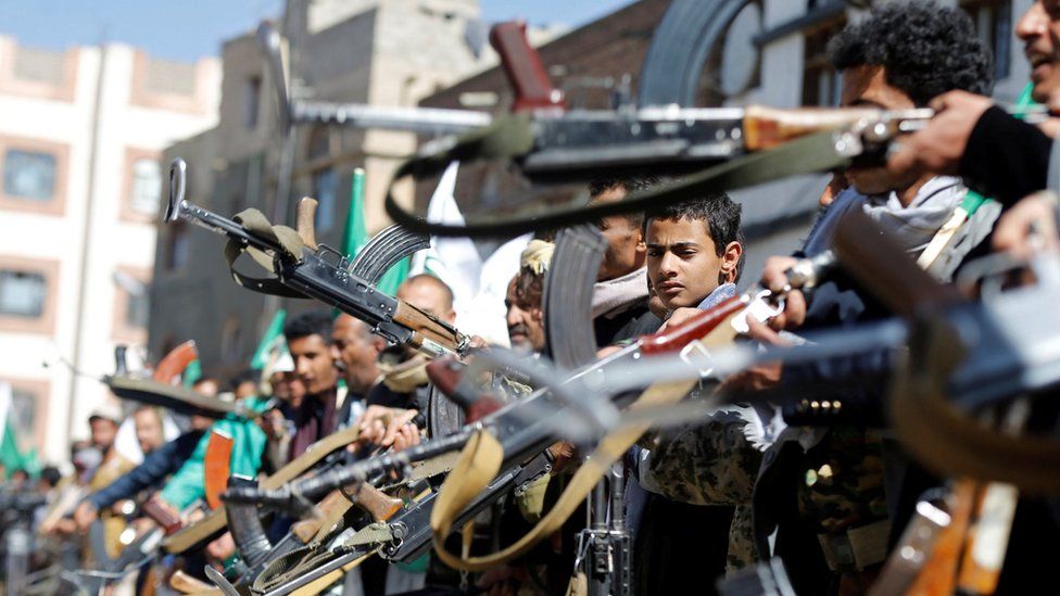 Houthi supporters hold up their weapons as they attend a gathering ahead of a rally celebrating the birthday of thee Prophet Mohammed in Sanaa, Yemen (28 November 2017)