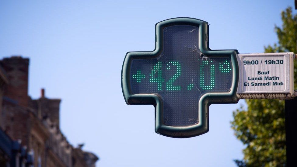 temperature reads 42 degrees from a pharmacy sign on a street in france