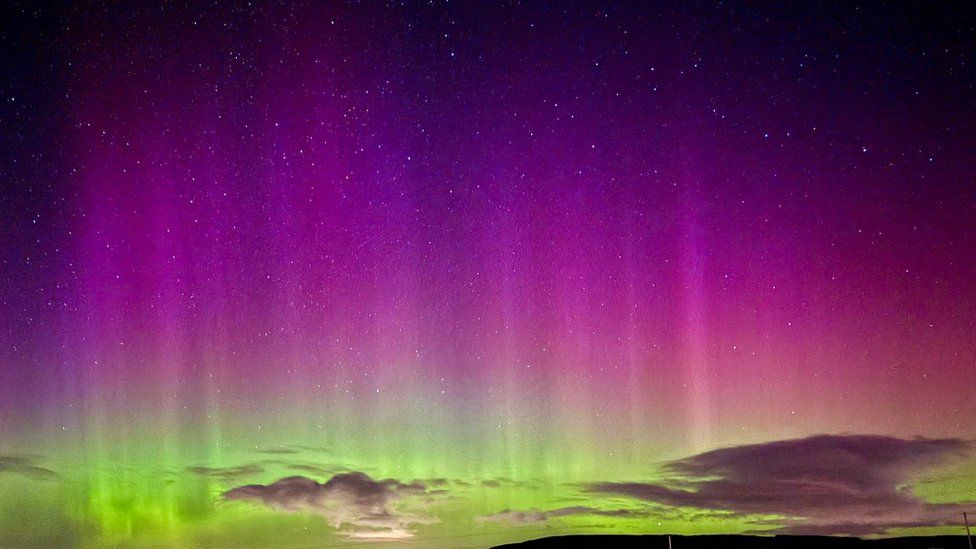 Sky filled with purple and green colours of the aurora.