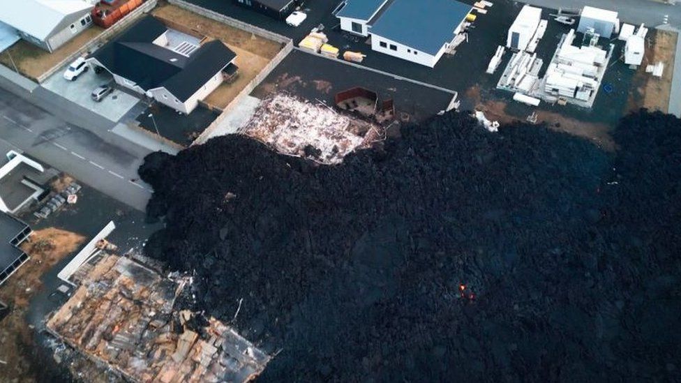 Overhead photo of blackened lava after recently erupted volcano burns down three houses in the town on January 15, 2024