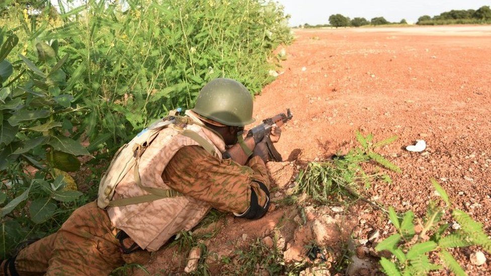 A Burkinabe soldier stands in position near the presidential guard's barracks on 29 September 2015 in Ouagadougou