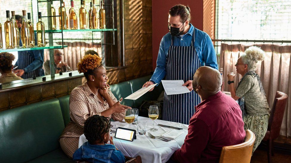 A general photo of people being served in a restaurant