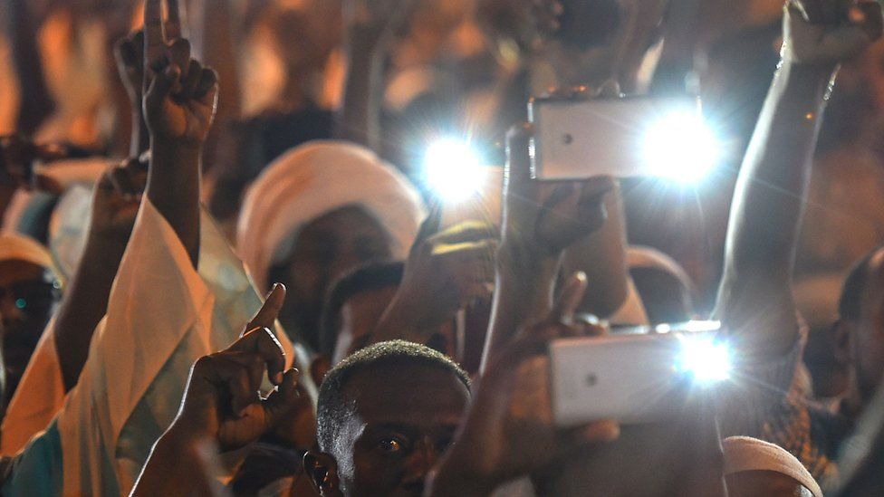 Demonstrators in Sudan with mobile phones at night - May 2019