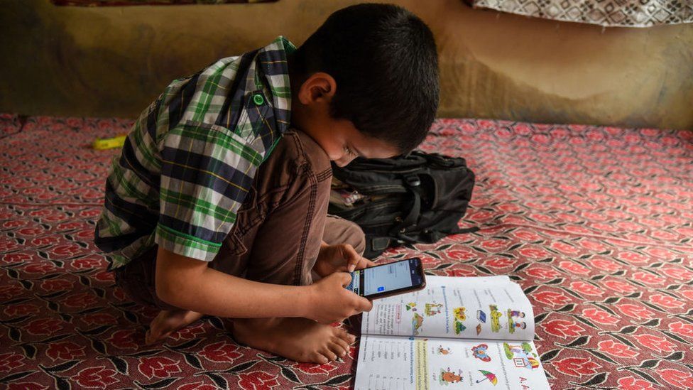 A Kashmiri student listen to the lecture (voice) of his teacher during an online class via Zoom app as schools remain closed amid the fight against the COVID-19 outbreak in Kashmir.