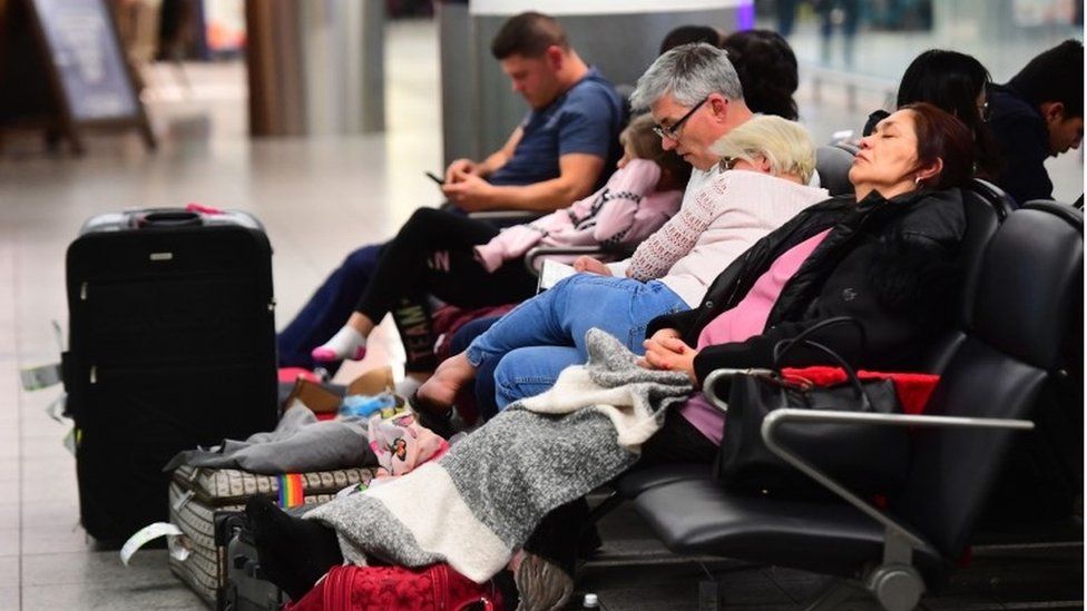 Passengers at Gatwick Airport sleeping
