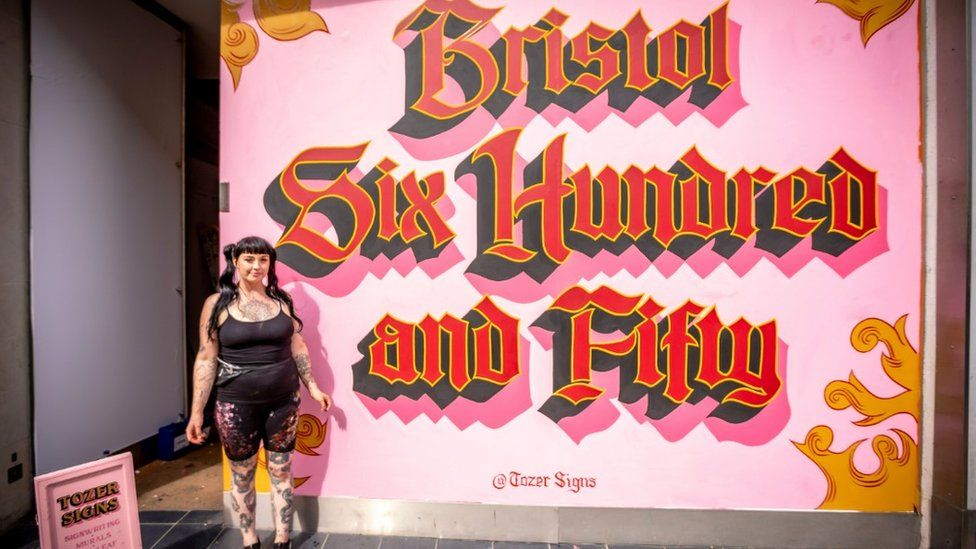 Artist in front of painting saying 'Bristol 650'