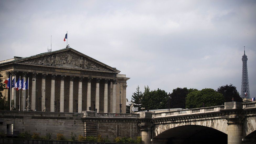A picture taken on June 15, 2015 in Paris shows the Palais Bourbon, seat of the French National Assembly and the Eiffel tower.
