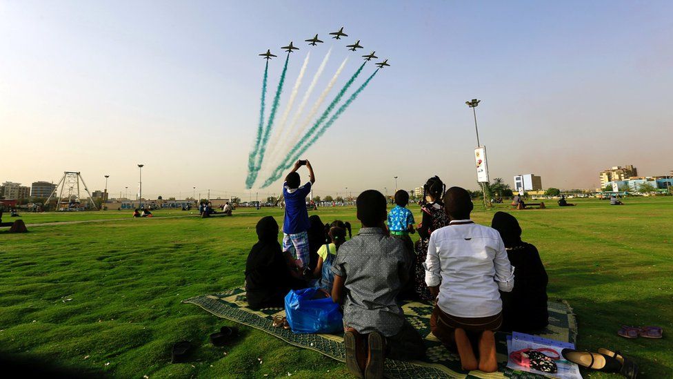 People look at Saudi Air Force perform from the Green Square near Khartoum Airport, Khartoum, Sudan, April 12, 2017