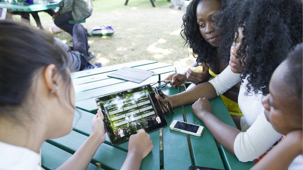 Women sharing data on a tablet