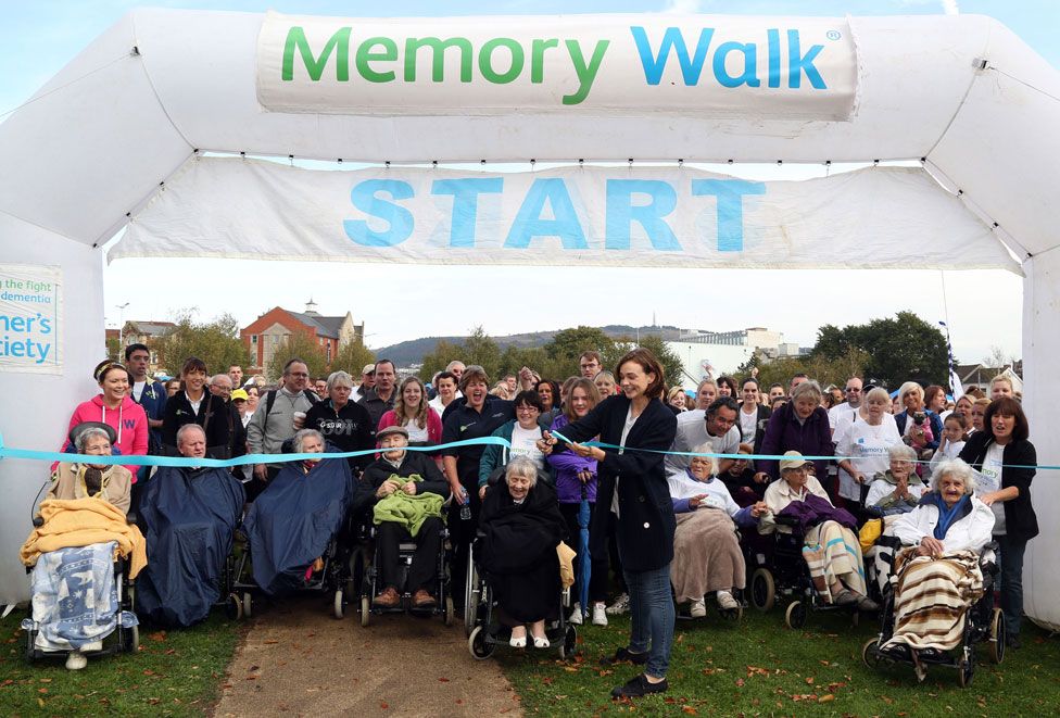 Actress Carey Mulligan (centre right) cuts the ribbon at the start of the Alzheimer's Society's Memory Walk in Museum Park in Swansea, Wales.