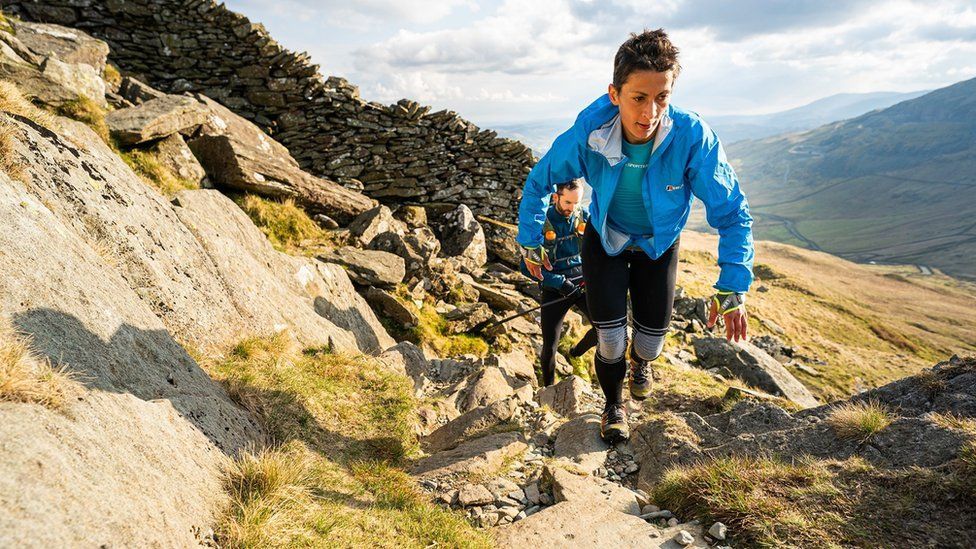 Sabrina Verjee running up a fell as part of her Wainwright challenge in June