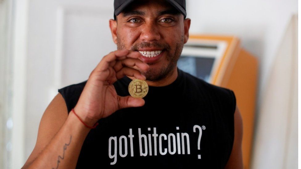 Bitcoin enthusiast Carlos Bonilla shows a physical representation of the cryptocurrency, at a Bitcoin Beach support office at El Zonte Beach in Chiltiupan, El Salvador.