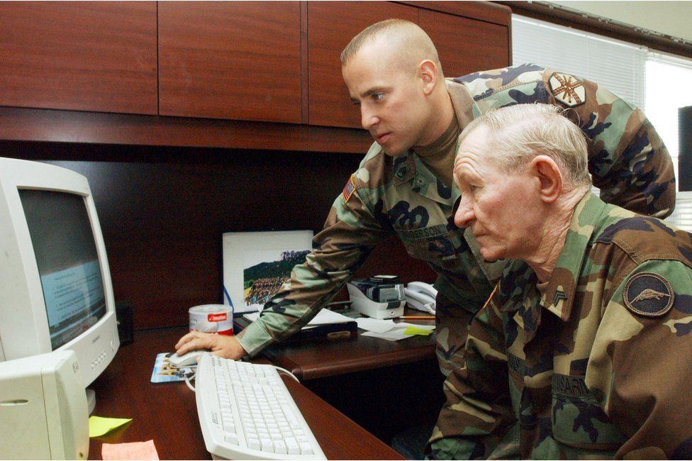 In this handout photo from U.S. Army, alleged U.S. Army deserter Sergeant Charles R. Jenkins (R) receives training on a computer from Staff Sgt. Andrew Rogerson, the U.S. Army Garrison Japan training noncommissioned officer and Jenkins's supervisor, at Camp Zama in 17 September 2004 in Zama, Japan