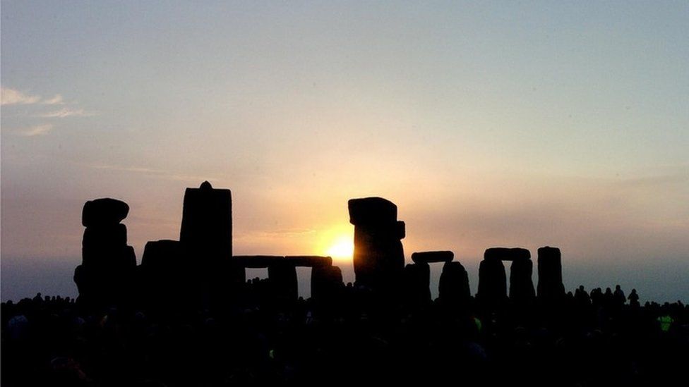 Sunrise over Stonehenge showing the silhouettes of the stones