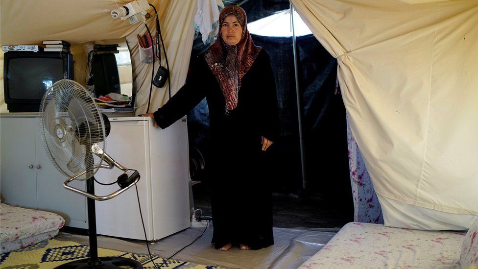 A Syrian refugee woman stands in her tent at a refugee camp in Osmaniye, Turkey, May 17, 2016