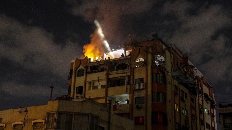 A photo shows a building on fire after a missile strike