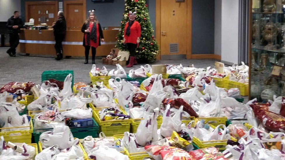 Everyone Deserves a Christmas hampers ready for delivery, with MP Carolyn Harris in the background