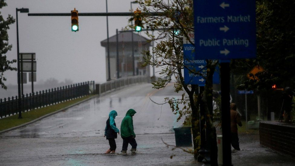 Two people walk in flooded streets in New Bern, North Carolina