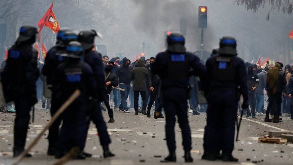 French riot police stand guard as members of the Kurdish community attend a demonstration, 24 December