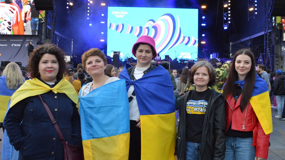 Fans with Ukrainian flags at the Eurovision village in Liverpool